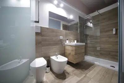 a bathroom with a toilet and a sink and a shower at Casa di Paola in Palermo