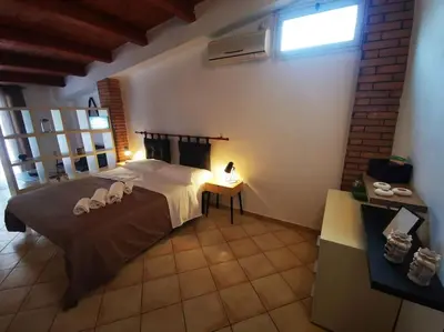 a bedroom with a large bed with towels on it at Kappa's house in Palermo