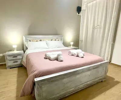 a bedroom with a large bed with two towels on it at Da Zia Maria in Palermo