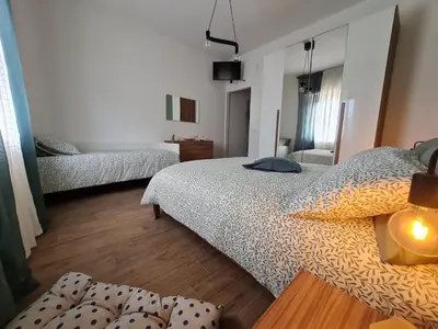 a bedroom with two beds and a table in it at La Chicca di Milu' for Pet Lovers in Alcamo