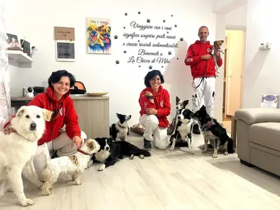 a group of people with dogs in a living room at La Chicca di Milu' for Pet Lovers in Alcamo