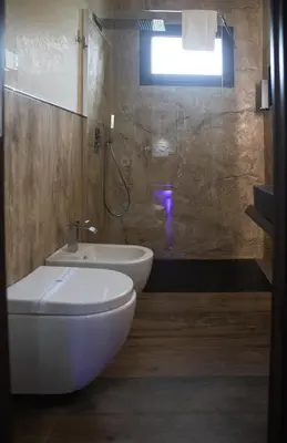 a bathroom with a toilet and a sink and a shower at Residence Villa Rosa dei Venti in Cinisi