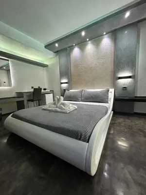 a bedroom with a large bed and a table at Residence Villa Rosa dei Venti in Cinisi