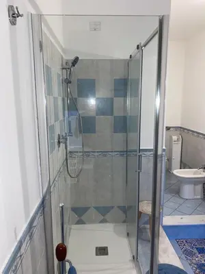a bathroom with a shower with a glass door at La Casa di Gus in Palermo