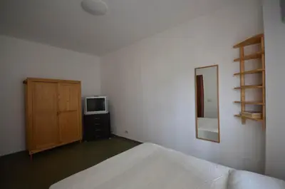 a bedroom with a bed and a cabinet and a television at Casa Garofani in Carini