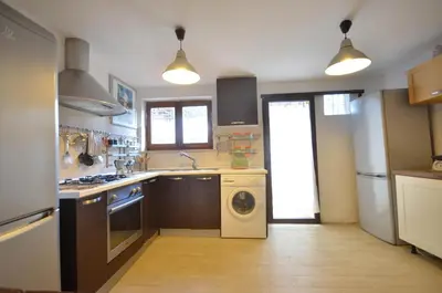 a kitchen with a sink and a washing machine at Casa Garofani in Carini