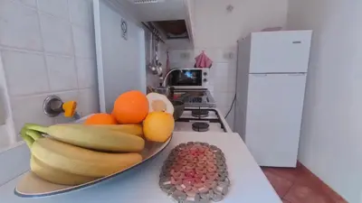 a plate of fruit on a counter in a kitchen at Casetta verde 1 Climatizzata in Castellammare del Golfo