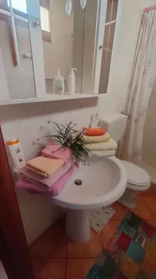 a bathroom with a sink and a toilet and a mirror at Casetta verde 1 Climatizzata in Castellammare del Golfo