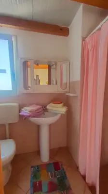 a small bathroom with a sink and a mirror at Casetta vista mare 2 Climatizzata in Castellammare del Golfo