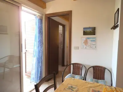 a dining room with a table and chairs and a window at Casetta vista mare 2 Climatizzata in Castellammare del Golfo