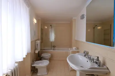 a bathroom with a sink and a toilet and a tub at Il Siciliano room’s & suite in Palermo