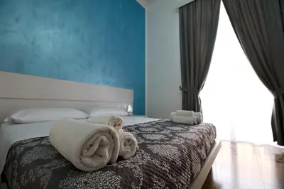 a bedroom with a bed with towels on it at Il Siciliano room’s & suite in Palermo