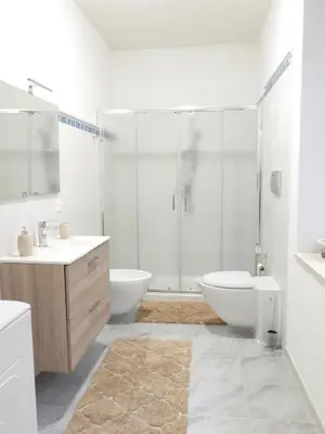 a bathroom with a shower and a toilet and a sink at Casa Lumìa in Palermo