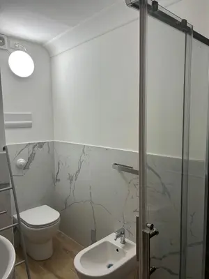 a bathroom with a toilet and a sink at Sikanart Home in Palermo