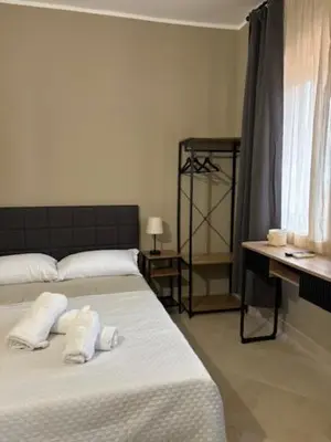 a bedroom with a bed with two towels on it at Sikanart Home in Palermo