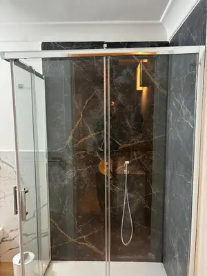 a shower with a glass door in a bathroom at Sikanart Home in Palermo