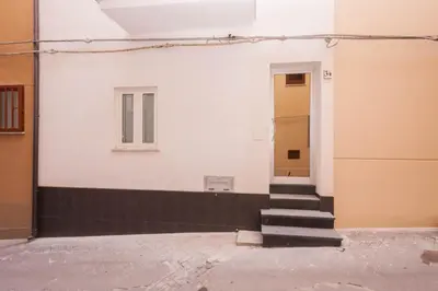 a stairway leading to a door in a building at Il Vittoria - Self Check in in Lascari