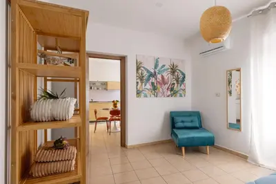a living room with a blue chair and a table at Palermo of living appartamento Centro Storico in Palermo