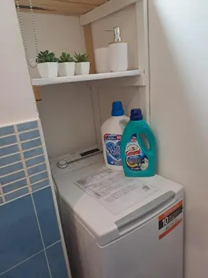a refrigerator with a bottle of detergent on top of it at Palermo of living appartamento Centro Storico in Palermo