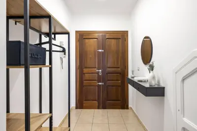 a staircase leading to a bathroom with a wooden door at Palermo of living appartamento Centro Storico in Palermo