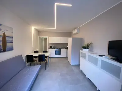 a living room with a kitchen and a dining room at Casa Penelope in Mondello
