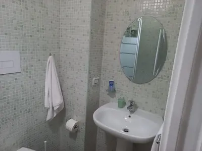 a bathroom with a sink and a mirror at Appartamento centro storico.(Nina's house Venezia) in Palermo