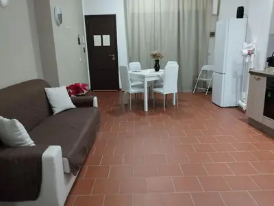 a living room with a couch and a table and chairs at Appartamento centro storico.(Nina's house Venezia) in Palermo