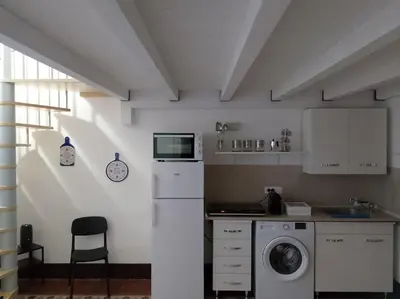 a kitchen with a washing machine and a sink at Appartamento centro storico(Nina's house stazione) in Palermo
