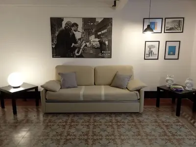 a living room with a couch and two tables at Appartamento centro storico(Nina's house stazione) in Palermo