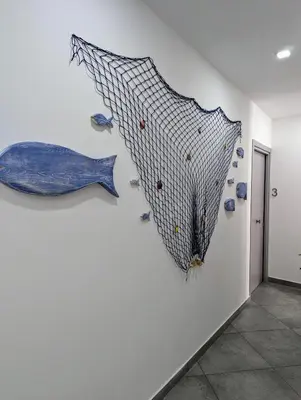 a painting of a blue fish on a wall at I colori della Sicilia in Cinisi