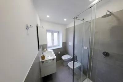 a bathroom with a shower and a sink and a toilet at Argenteria5 Holiday Rooms in Palermo