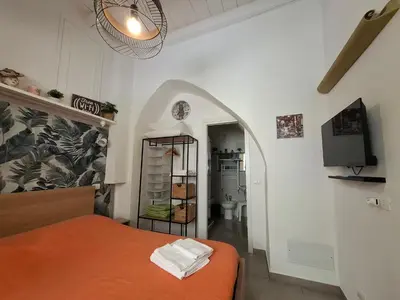 a bedroom with an orange bed and a tv at Holiday Home Celsus 84 in Palermo