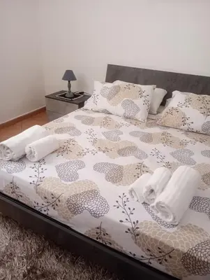a bedroom with a bed with a comforter and pillows at L' Arco Antico in Palermo