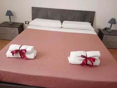 a bed with towels and bows on top of it at L' Arco Antico in Palermo