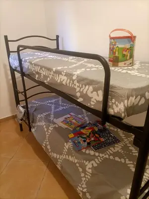 a bunk bed with a comforter on top of it at L' Arco Antico in Palermo