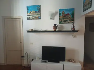 a television sitting on a white cabinet in a room at Appartamento Alessandro al porto in Palermo