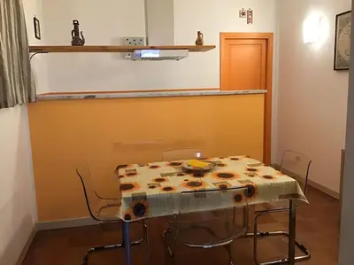 a table and chairs in a room with a counter at Appartamento Alessandro al porto in Palermo
