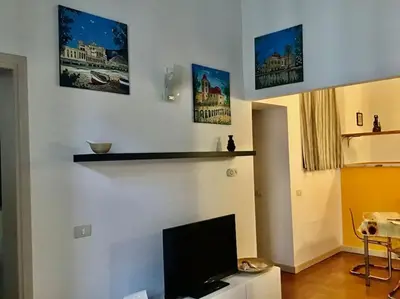 a living room with a flat screen tv on a wall at Appartamento Alessandro al porto in Palermo