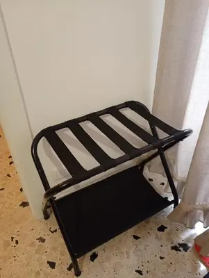 a black and white bench sitting next to a wall at Lascaris 11 in Palermo