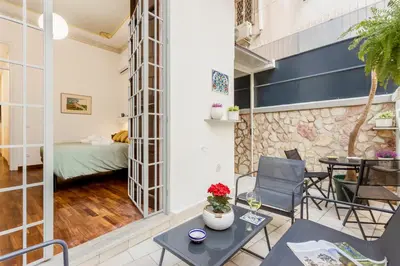 a bedroom with a bed and a desk with a computer at Cicco's Home - Holidays Apartment in Palermo