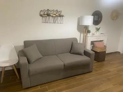 a living room with a couch and a table at Reef Mondello Apartment in Palermo