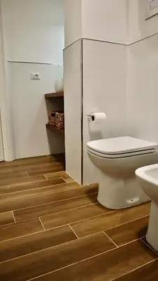 a bathroom with a toilet and a sink at Reef Mondello Apartment in Palermo