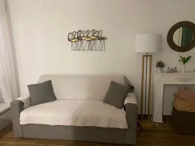 a living room with a couch and a fireplace at Reef Mondello Apartment in Palermo