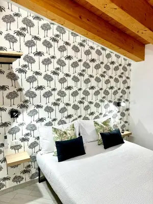 a bedroom with a bed with a wall covered in umbrellas at 4Rooms in Palermo