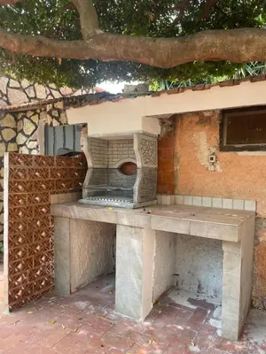an outdoor kitchen with a table and a stove at La Villetta di Sofia in Carini