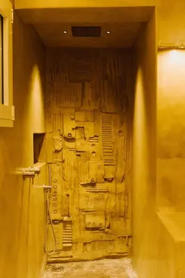 a wooden door in a wall in a room at QUIETE e MARE in San Vito lo Capo