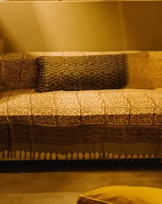 a bed with a pillow on top of it at QUIETE e MARE in San Vito lo Capo