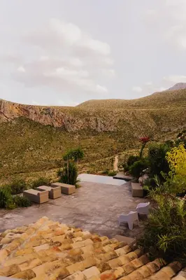 a garden with a view of a mountain at QUIETE e MARE in San Vito lo Capo