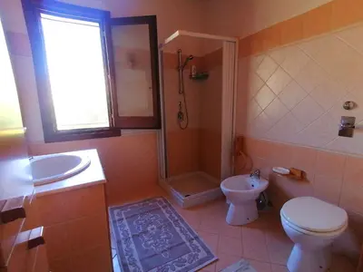 a bathroom with a toilet and a shower and a sink at Villa Francesca in Castelluzzo
