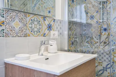 a bathroom with a sink and a shower at Vista Mare Rooms in Isola delle Femmine